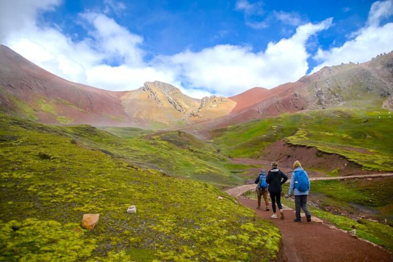 Hikers walking on trail to Palccoyo Rainbow Mountain in Cusco Peru Andes landscape